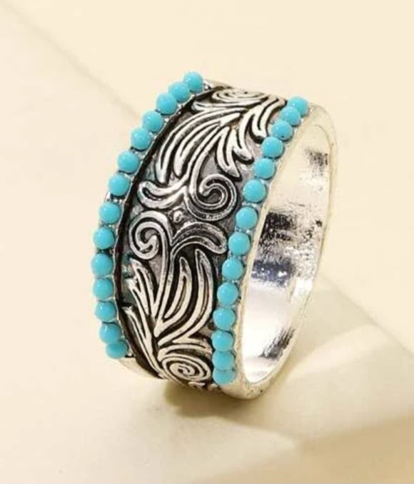 scrollwork and teal ring